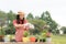 Asian woman care plant flower in garden. Asian people hobby and freelance gardening outdoor sunnyÂ  nature background.